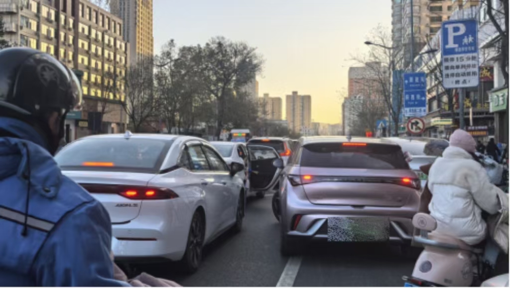 旱西關(guān)街旱西關(guān)南二條路口，送學(xué)車輛在直行車道停車下人。車門推開時(shí)，后方粉色車輛剛剛向左前方起步，險(xiǎn)些發(fā)生磕碰。人民網(wǎng)記者王晏如攝